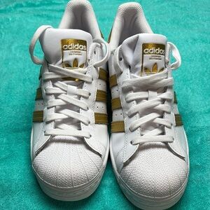 Adidas White Sneakers with Gold Stripes